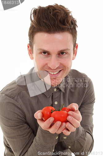 Image of Young man offering tomatoes