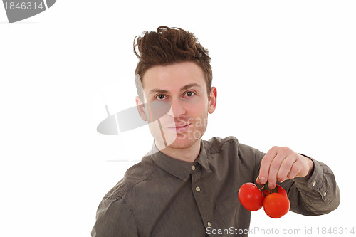 Image of Portrait of young man holding tomatoes