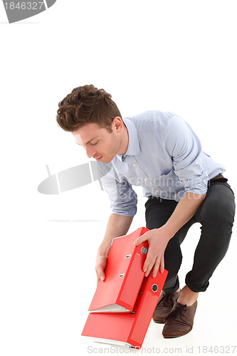 Image of Young employee with falling folders