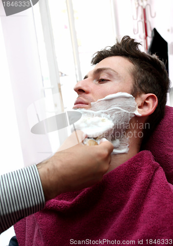 Image of Portrait of young man at barber shop