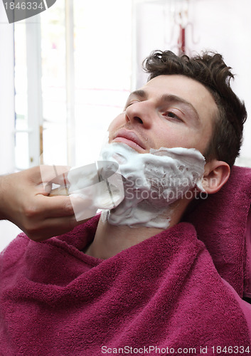 Image of Portrait of young man at barber shop