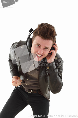 Image of Young adult male louding and listening music