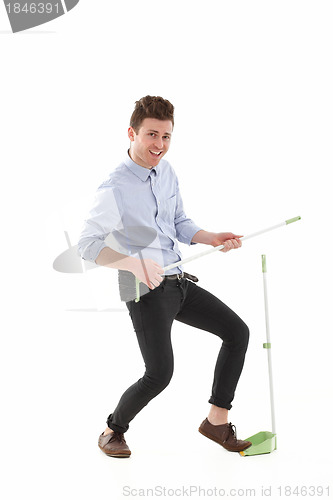Image of Handsome man dancing and cleaning