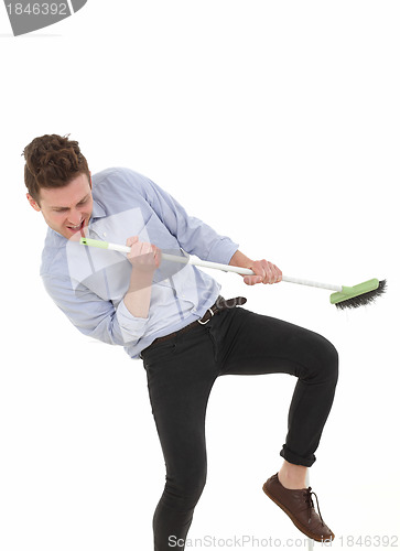 Image of Handsome man dancing and cleaning