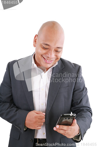 Image of Portrait of an African American businessman text messaging 