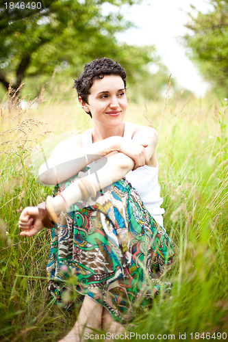 Image of cute girl resting on fresh spring grass 