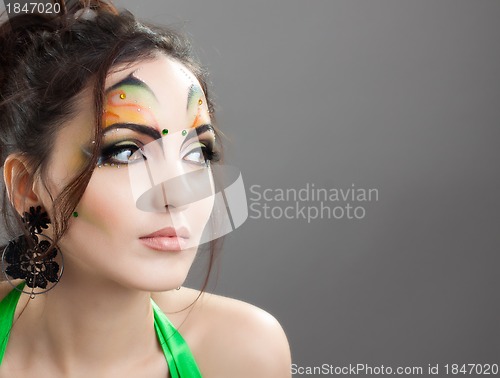 Image of Cute girl with proffesional make up looking somewhere