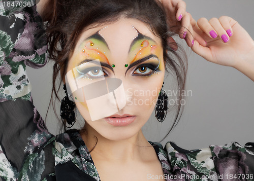 Image of Portrait of cute girl with idnian make up and earrings