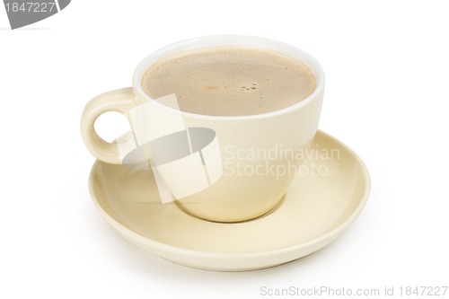 Image of small white cup of cappuccino coffee on light background