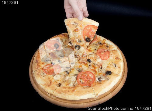 Image of Pizza and slice of pizza in hand