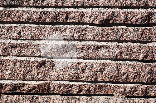 Image of closeup of surface reddish granite block