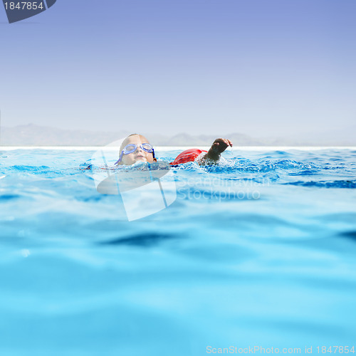 Image of Boy in infinity pool