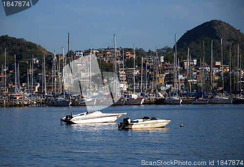 Image of Slum near the sea, with rich boats and yachts in front