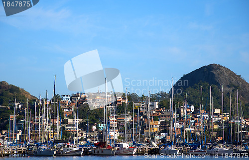 Image of Slum near the sea, with rich boats and yachts in front