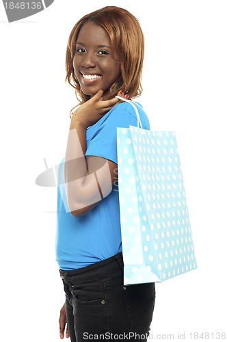Image of Satisfied lady shopper with shopping bag