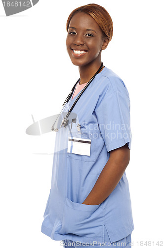 Image of African female nurse posing casually in uniform