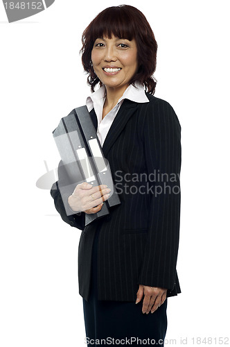 Image of Smiling businesswoman holding her file folder