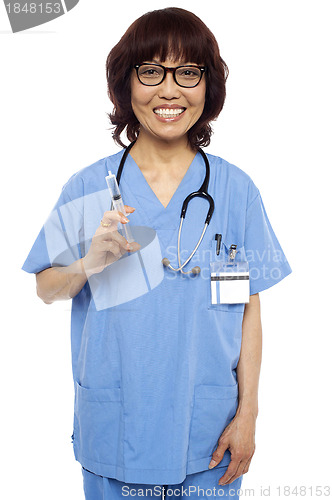 Image of Experienced female pediatrician ready with a syringe