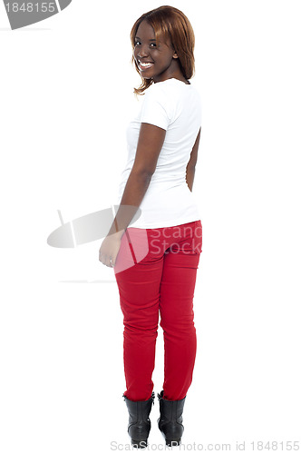 Image of Smiling african lady in boots turning back, full length shot