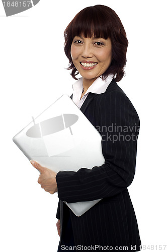 Image of Asian corporate female holding laptop