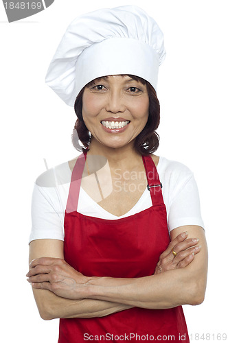 Image of Confident smiling chef posing with her arms crossed