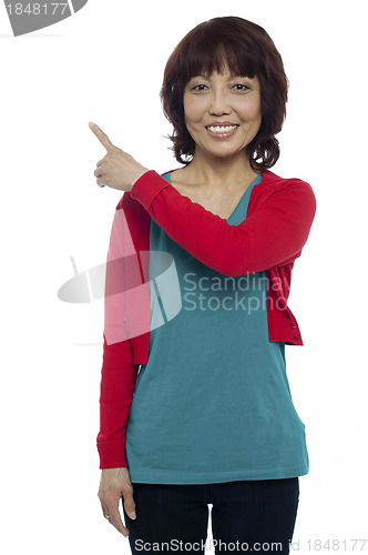 Image of Asian model pointing at the copy space area