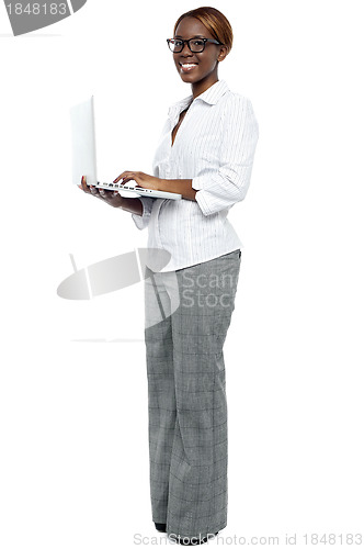 Image of African businesswoman working on laptop