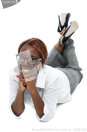 Image of Relaxed african businesswoman lying on floor