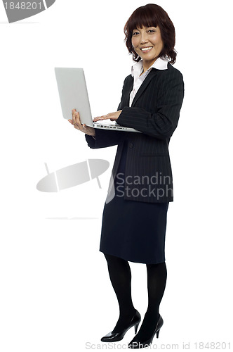 Image of Lets get back to work. Woman with laptop