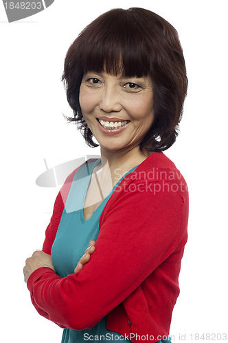 Image of Side pose of smiling asian woman, arms crossed