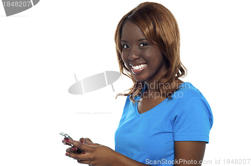 Image of African girl messaging her friends