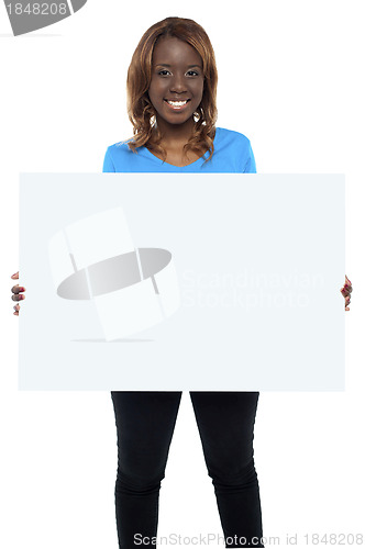 Image of Smiling african female model holding billboard