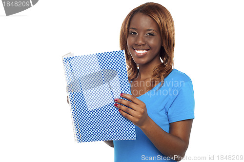 Image of Smiling college student holding notebook