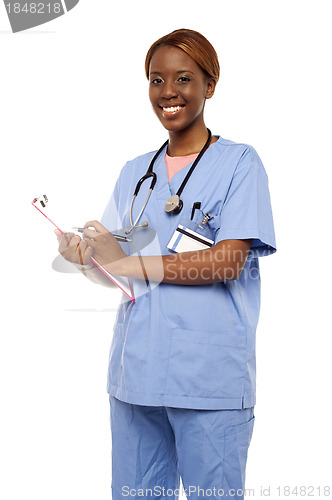 Image of Female surgeon writing medical prescription