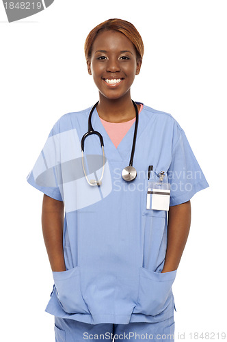 Image of Relaxed female surgeon posing with hands in her coat