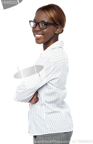 Image of African business executive smiling with crossed arms