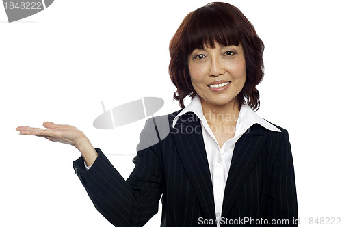 Image of Smiling asian female presenting copy space