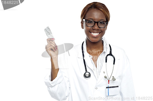 Image of Female doctor holding pack of medicine