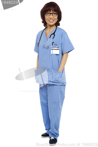 Image of Asian surgeon posing with hands in her uniform