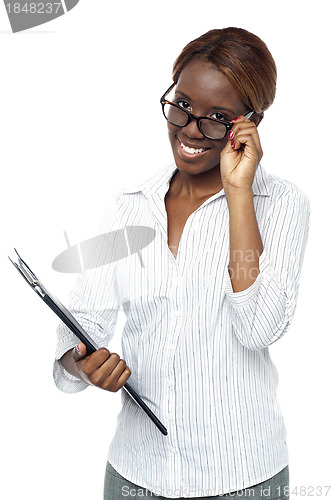 Image of Businesswoman holding file and adjusting her spectacles