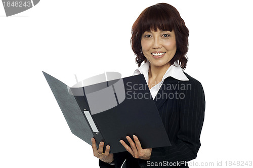 Image of Young female asian boss going through the file