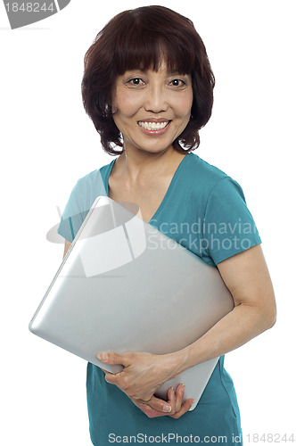 Image of Casual woman carrying her laptop