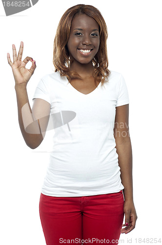Image of Smiling african young girl gesturing okay sign
