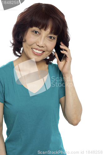 Image of Pretty female communicating through cellphone