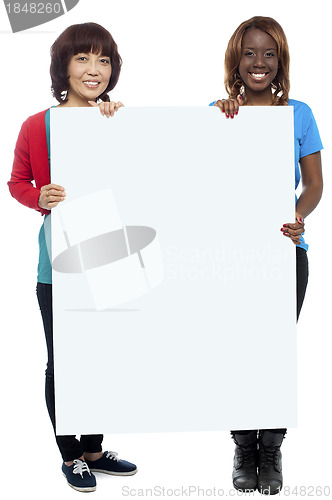 Image of Big billboard presented by casual girls. Full length