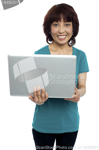 Image of Casual asian girl holding laptop