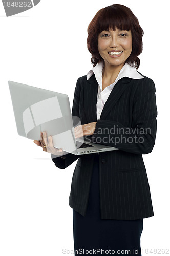 Image of Portrait of a businesswoman working on laptop