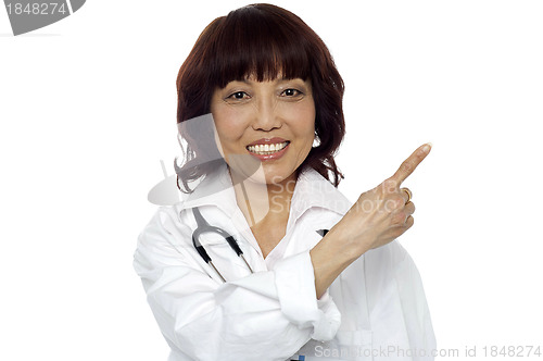 Image of Matured surgeon pointing at the copy space