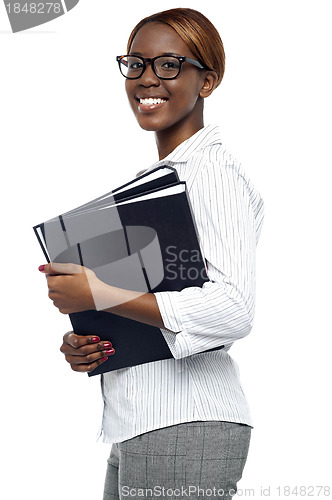 Image of Female secretary carrying office files