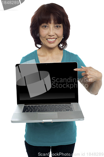 Image of Saleswoman presenting you brand new laptop